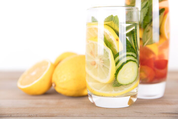 Two glasses of lemon slices, cucumber slices and mint leaves infused beauty water and fresh lemon...
