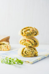 Home made buns with garlic, green parsley and sweet pepper in a napkin white background.