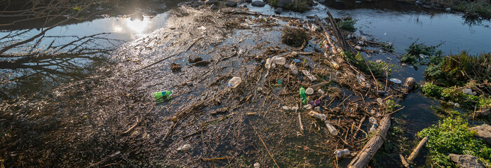 Environmental problem. Plastic waste in the river, pollution and the environment in the water.