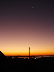 sunset over the city. Sky purple and moon.