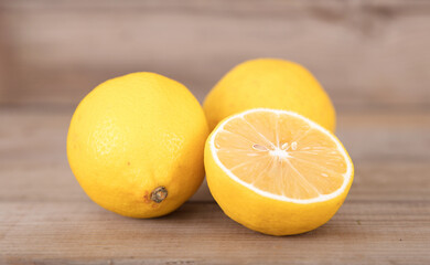 Two fresh lemons and half a cut lemon