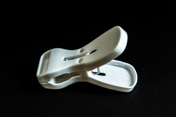 White Clothespin on Black Background