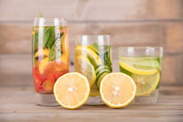 Three cups of lemon mint tea and lemon fruit cut in half
