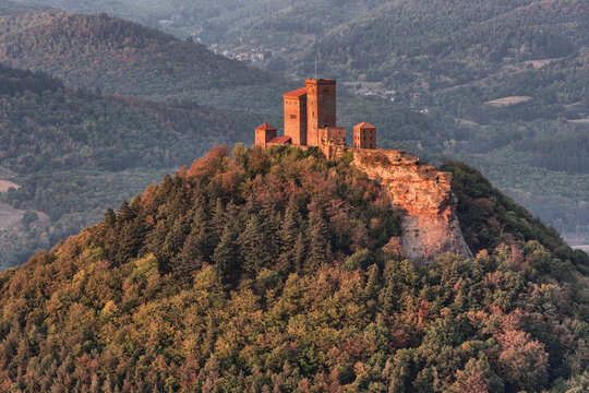 Trifels Castle in the Palatinate Forest, located on a ridge, is illuminated by the evening sun