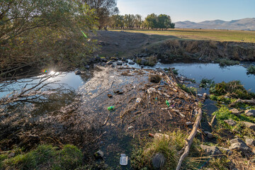 Environmental problem. Plastic waste in the river, pollution and the environment in the water.