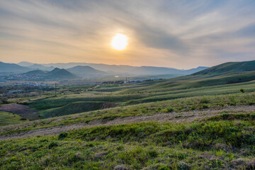 View of the city of Koktebel in the Crimea at sunset, against the background of mountains