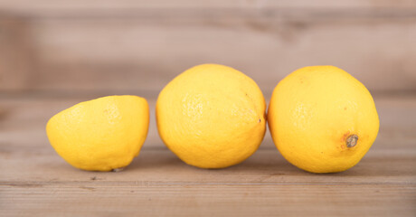Two fresh lemons and half a cut lemon