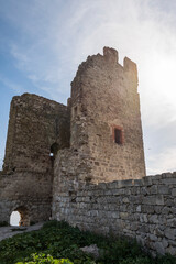 Fototapeta na wymiar Medieval wall and tower of Genoese fortress in the city of Feodosia on the Crimean Peninsula, built by colonists from Genoa in the 14th century