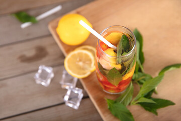 A glass of iced lemon mixed fruit tea and a straw in summer