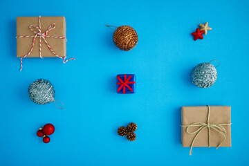 Gift boxes and Christmas decorations on the blue surface