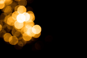 Gold bokeh from light in water with black background