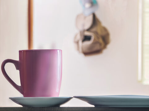 cup of hot chocolate accompanied by a piece of paneton on a wooden surface with an unfocused background