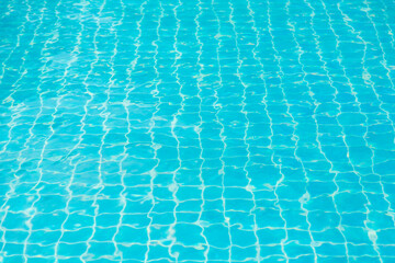 Reflections from the water in the blue swimming pool