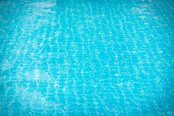 Reflections from the water in the blue swimming pool