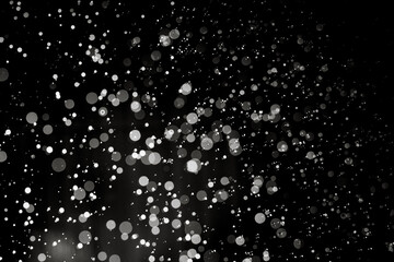 Abstract elegant glitter sparkle bokeh defocused on black background
