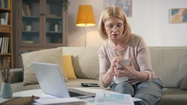 Medium Footage Of Caucasian Business Woman Working From Home Having Video Chat With Financial Consultant About Bills And Payments Nodding In Response