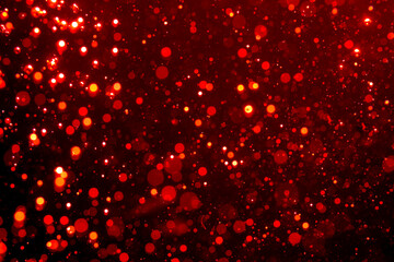 Red light glowing defocused holiday blurr bokeh in black backgeound