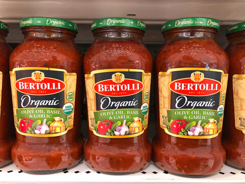 Alameda, CA - Oct 28, 2020: Grocery store shelf with bottles of Bertolli Organic Olive Oil, Basil and Garlic pasta sauce.