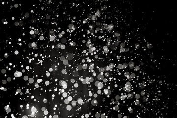 Abstract elegant glitter sparkle bokeh defocused on black background