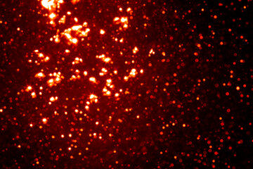 Fototapeta na wymiar Red bokeh of light textured glitter background