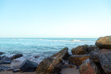 Waves on the seaside rocks are splashing on the rocks natural background