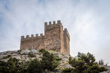 Fototapeta premium Bottom view of the tower of Genoese fortress of the 14th century in the Sudak bay on the Peninsula of Crimea