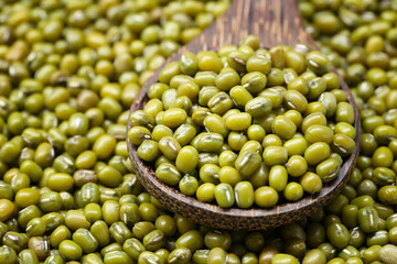 Fresh seed green beans in wooden spoon.