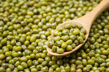 Fresh seed green beans in wooden spoon.