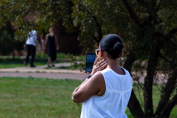 Lady wearing white taking a selfie