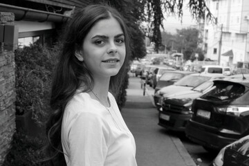 Portrait of a young girl posing in the street