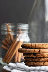 Ginger snap cookies with cinnamon sticks and empty milk bottle
