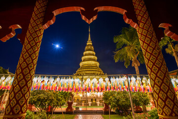 The scenery of Wat Phra That Hariphunchai at dusk on Loy Krathong Festival that decorated with...