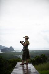 woman with a hat standing to admire the view
