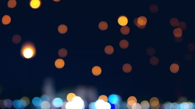 Blurry focus,  Floating lanterns in the night sky. Launching Sky Lantern. Yee Peng Festival, Loy Krathong celebration.