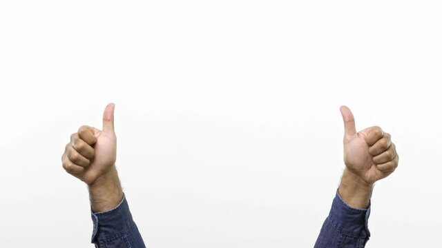 Close up of Man’s hand gestures. Approval like. Man showing thumb up isolated on white copy-space background. 4K Resolution.