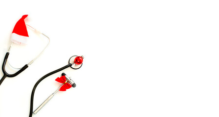 Christmas, New Year's medical flatlay. Stethoscope, neurological hammer, gift, Christmas decorations on a white background. Copy space.