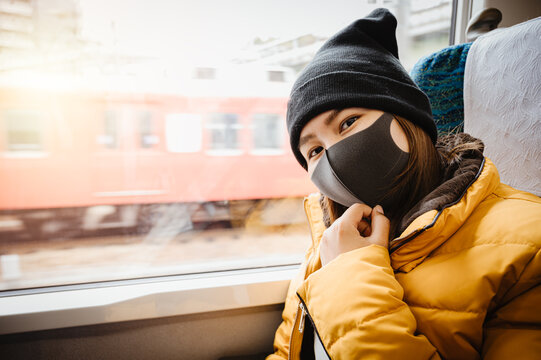 Woman Travel In Japan Winter Season ,Asian Woman Tourist Travel In Japan Wearing Face Mask.New Normal Travel Concept.vintage Tone