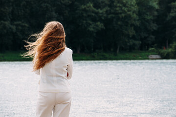 woman standing backwards and watching magic landscape.