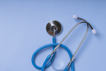 Close-up of Blue stethoscope of doctor for checkup on blue background. Top view . Copy space