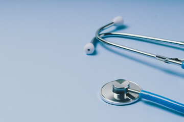 Close-up of Blue stethoscope of doctor for checkup on blue background