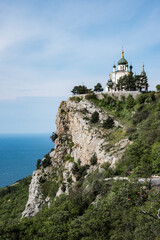 Fototapeta na wymiar Orthodox Church of the Resurrection built at an altitude of 412 meters over the village of Foros in 1892 on the Red Rock cliff. Monument of Russian architecture of the late XIX century