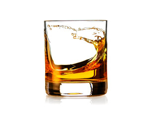 Whiskey splashing in glass isolated on white background