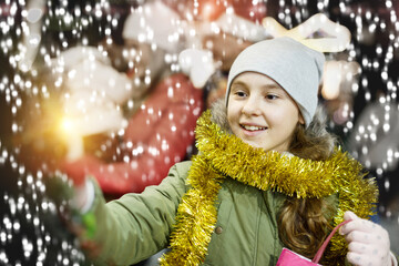 Close up portrait of cheerful teenage girl spending time at Christmas fair