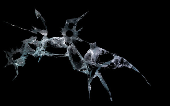 broken mirror and glass from impact on a black background in cracks in the form of an isolated abstraction