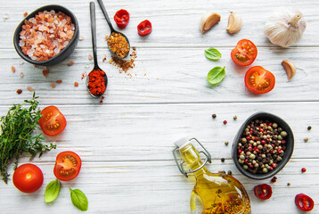 Tomato, basil and pepper with garlic on white wooden background