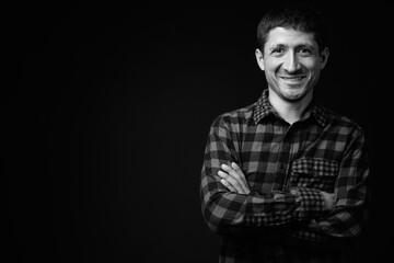 Portrait of Hispanic hipster man against black background