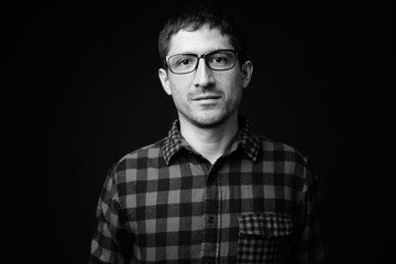 Portrait of Hispanic hipster man against black background