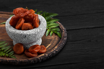 dried apricots on a dark wood background. tinting. selective focus