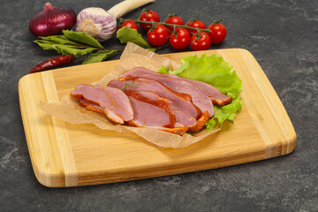 Sliced smoked duck breast served salad