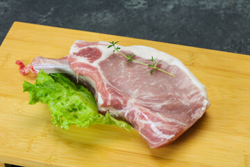 Raw pork bone steak over wooden